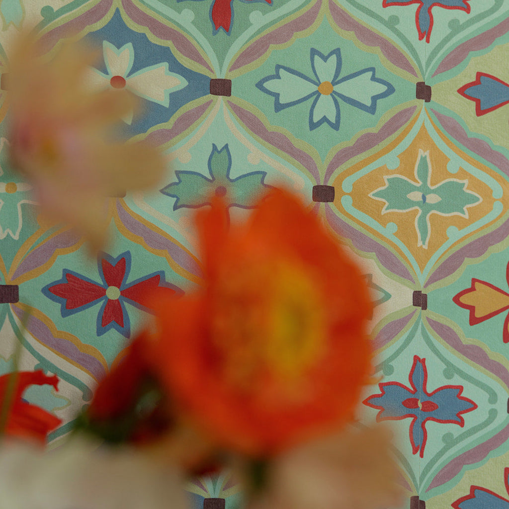 Floral arrangement with a colorful patterned wallpaper background