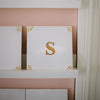 white tiles with mustard delft design and the letter s