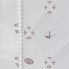 Decorative white tiles with manganese floral patterns and illustrations of the golden gate bridge and an apple pie