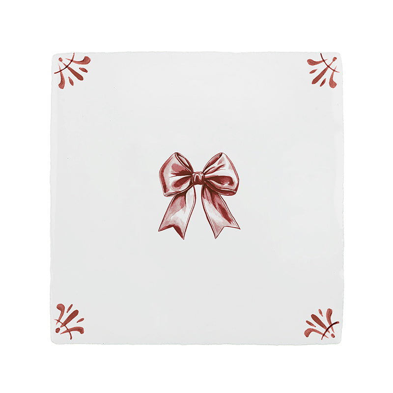 White tile with a crimson bow design on a white background