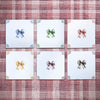 Set of white tiles with bow illustration in blue, green, crimson, mustard, manganese, sepia