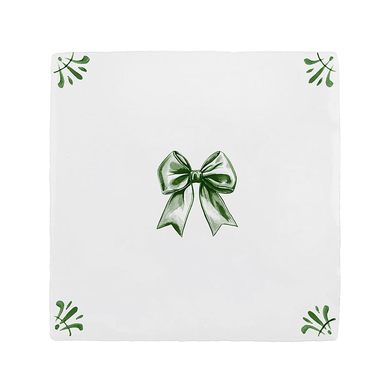 White tile with green bow design on a white background