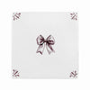 White tile with amanganese bow design on a white background