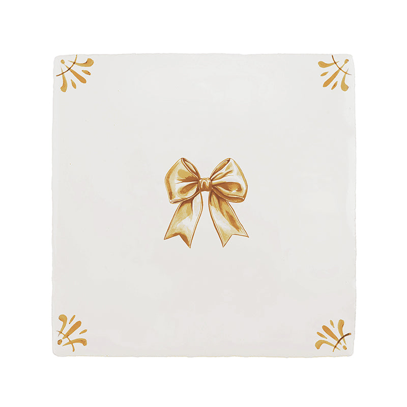 White tile with a mustard bow design on a white background