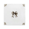 White tile with a sepia bow and decorative elements on a white background