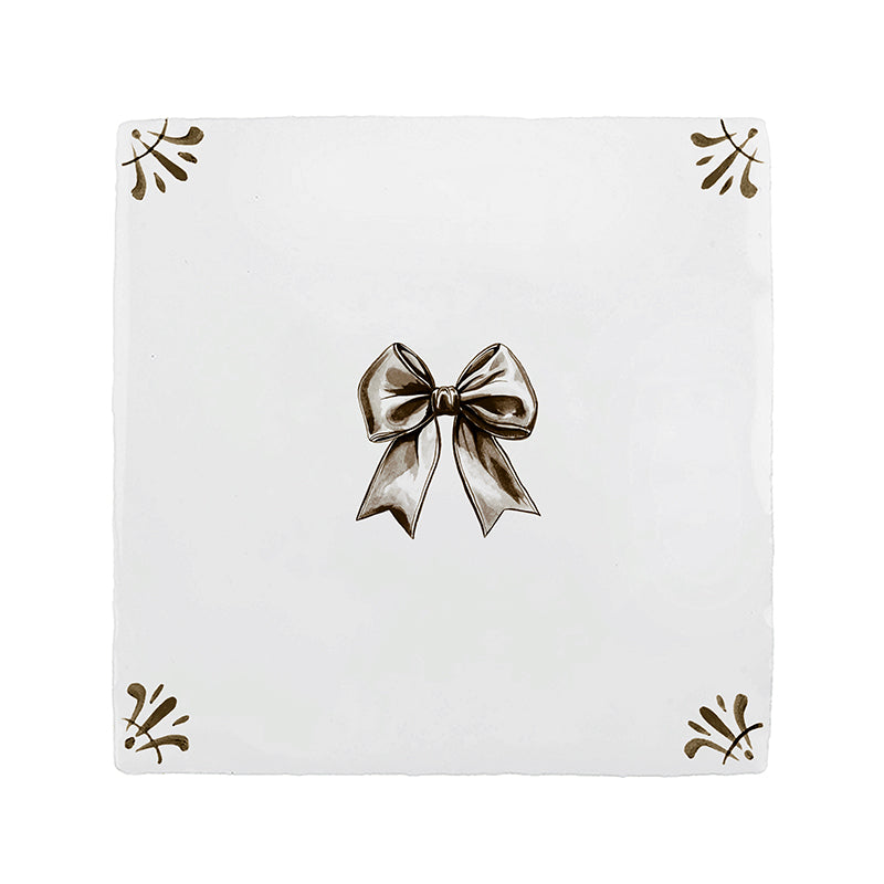 White tile with a sepia bow and decorative elements on a white background