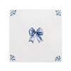 White tile with blue decorative bow and floral patterns on a white background