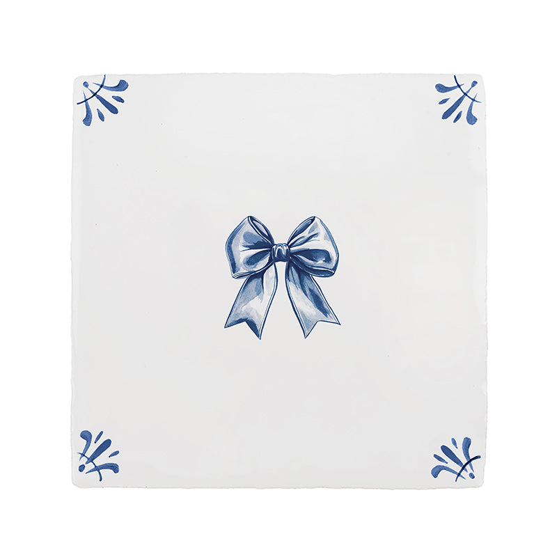 White tile with blue decorative bow and floral patterns on a white background