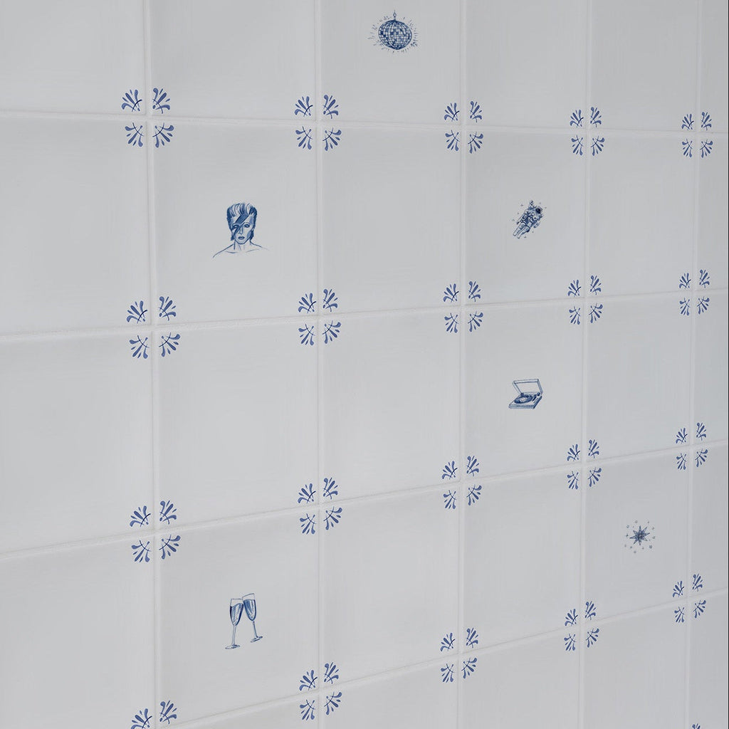 White tiles with blue patterns and David Bowie themed illustrations