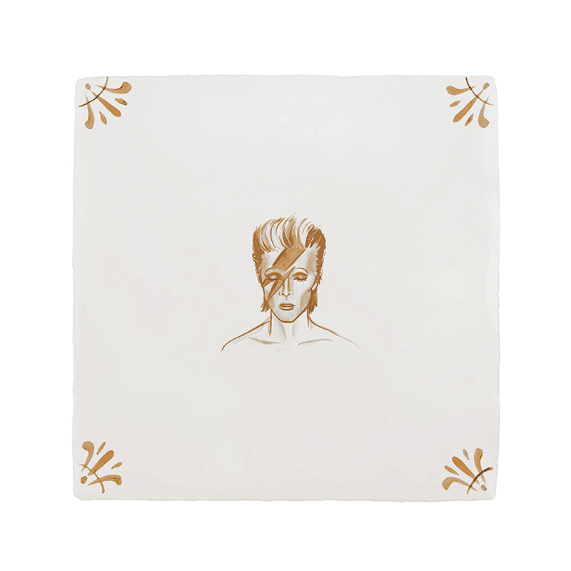 White tile with a mustard patten and illustration of David Bowie