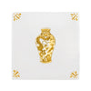 White tile with a mustard chinese vase design and decorative elements on a white background