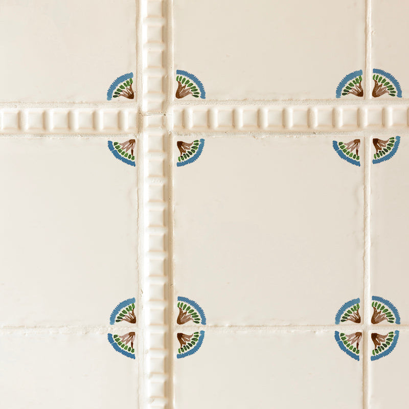 Decorative tiles with a corner floral design on a white background