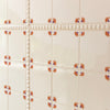 Decorative tile pattern with small floral designs on a white background