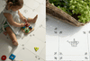 on the left an overhead of a toddler playing on a tiled floor with colourful wooden shaped blocks. On the right a natural broom sweeps a delft tiled floor with a wicker basket holding green flowers in view.