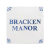 A square white decorative tile or plaque with the words 