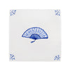 White tile with blue decorative fan pattern on a white background
