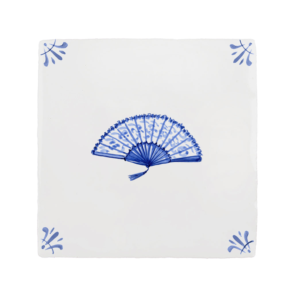 White tile with blue decorative fan pattern on a white background