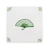 White tile with green decorative fan pattern on a white background