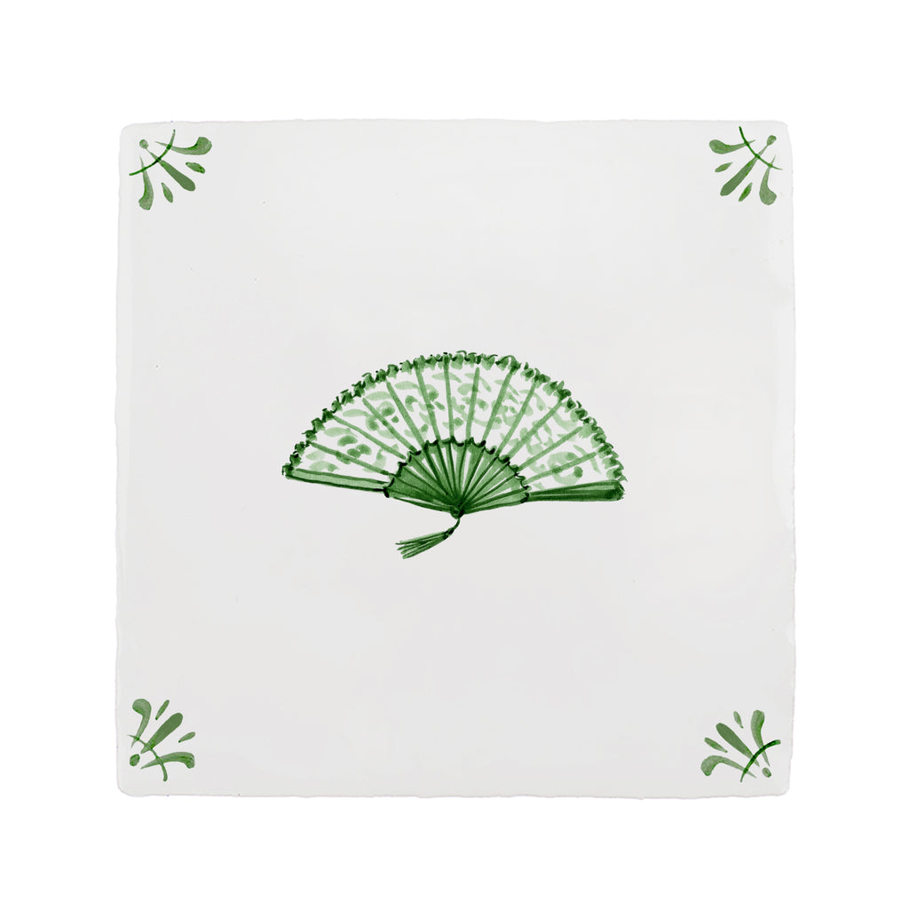 White tile with green decorative fan pattern on a white background