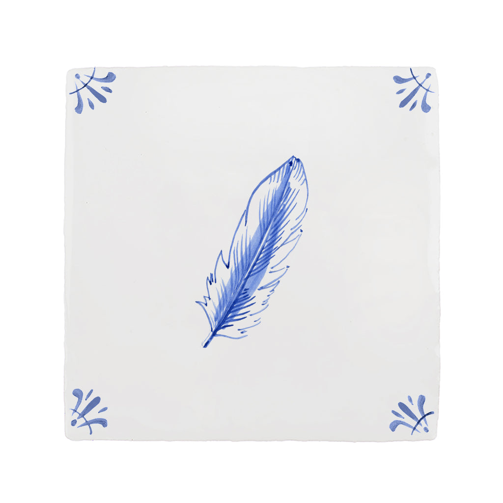 White tile with blue feather design on a white background