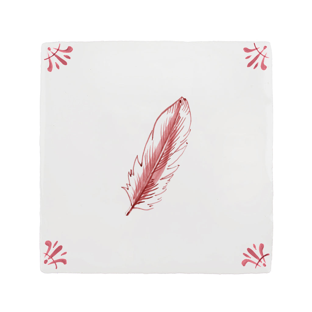 White tile with red feather design on a white background