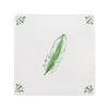 White tile with green feather design on a white background