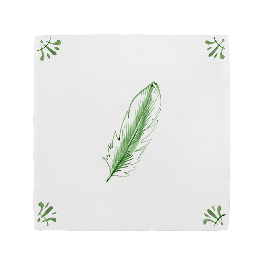 White tile with green feather design on a white background