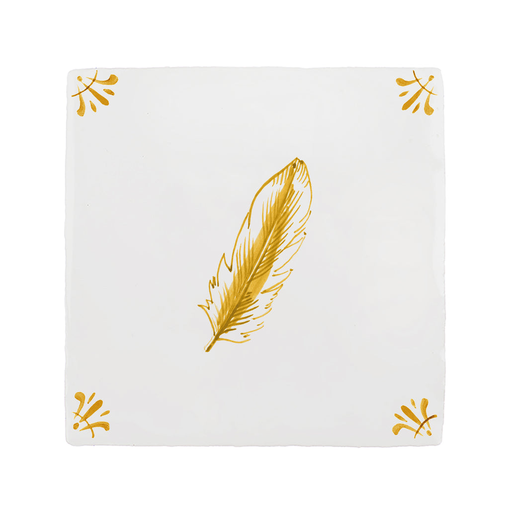 White tile with mustard feather design on a white background