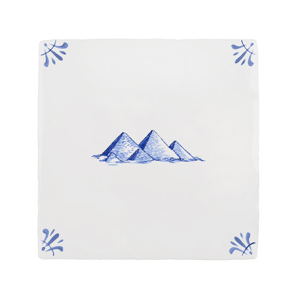 White tile with blue pyramids design and decorative elements on a white background