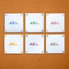 Six tiles with pyramid designs in different colors on a brown background