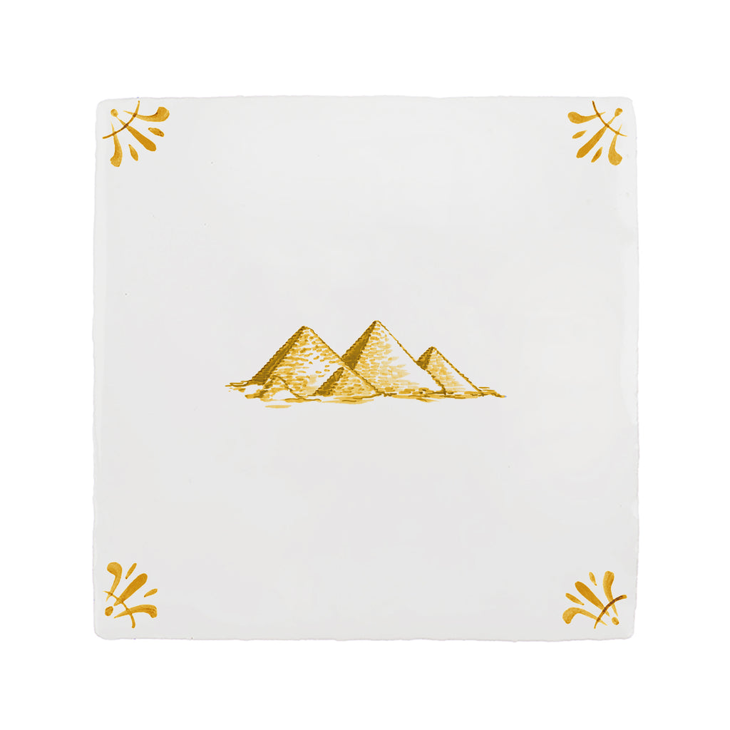 White tile with mustard yellow pyramid design on a white background