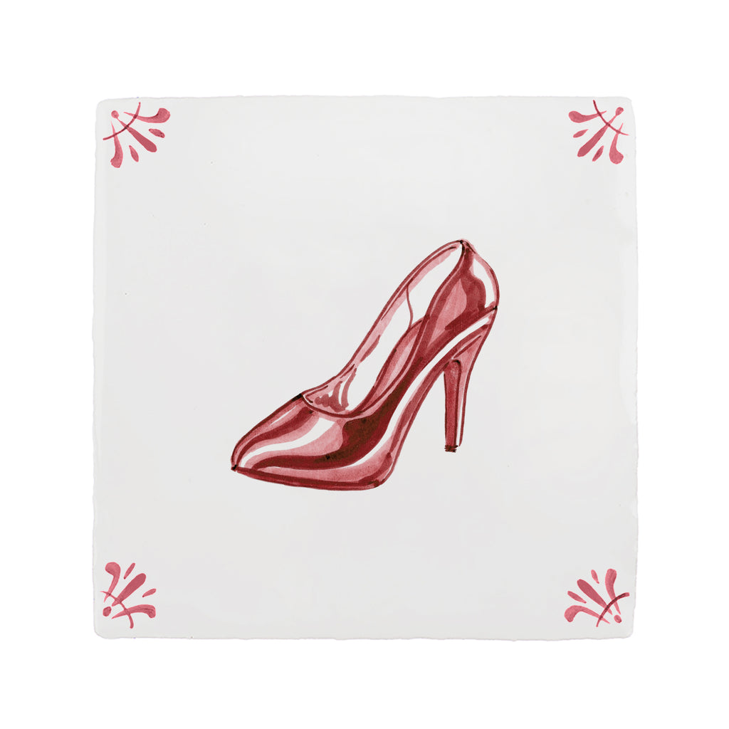 Red high-heeled shoe on a white tile background with decorative corner patterns