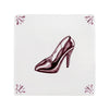 High-heeled shoe design on a decorative tile with floral patterns.