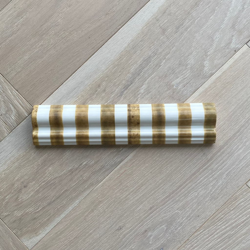 Striped dado tile trim on a wooden floor