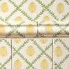 Patterned tiles and wallpaper with yellow ladybirds and green leaves on a beige background