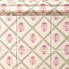Patterned tiles with pink and green ladybird design on a white background
