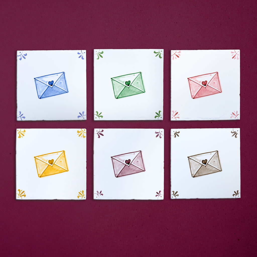Six colorful envelopes with heart designs on a purple background