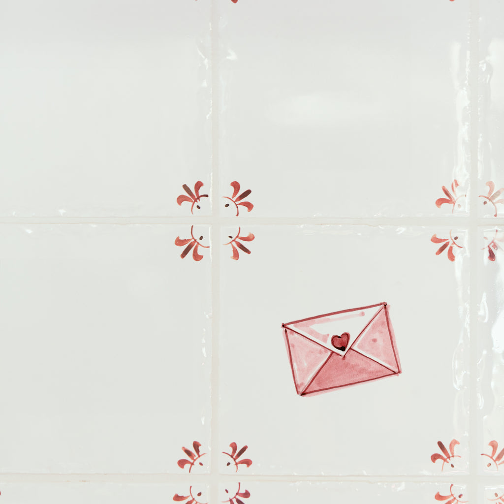 Decorative tiles with a love letter and heart design on a white background