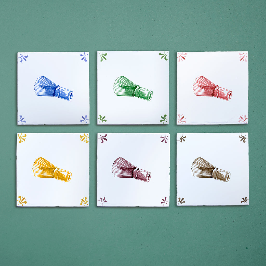 Set of six tiles with colorful illustrations of matcha whisks on a green background