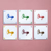 Six tiles with colorful megaphone illustrations on a pink background