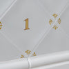 White tiled wall with mustard decorative elements and number '1'.