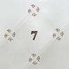 Close-up of a tiled white surface with decorative patterns and a number '7'.