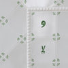 White tiles with green floral patterns and a number '9' on a white background