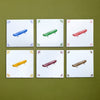 Six tiles with colorful illustrations of skateboards on a green background
