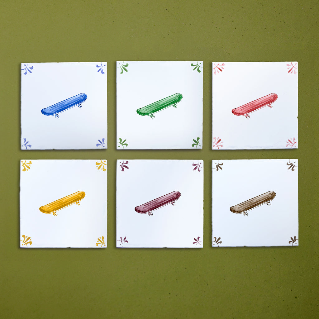 Six tiles with colorful illustrations of skateboards on a green background