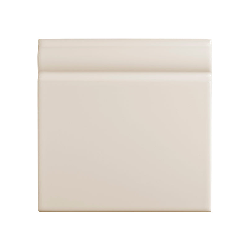 Cream ceramic skirting board tile on a white background