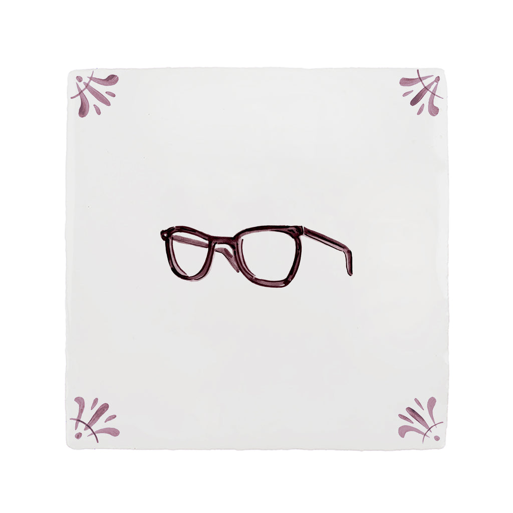 Pair of glasses on a white tile with decorative corner designs