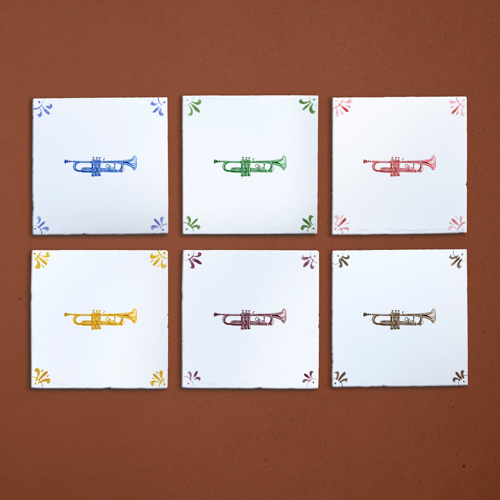 Six tiles with colorful trumpet illustrations on a brown background