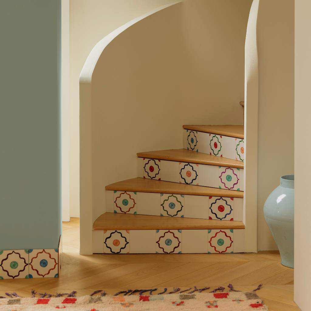 Staircase with decorative tiles on a wall with arches