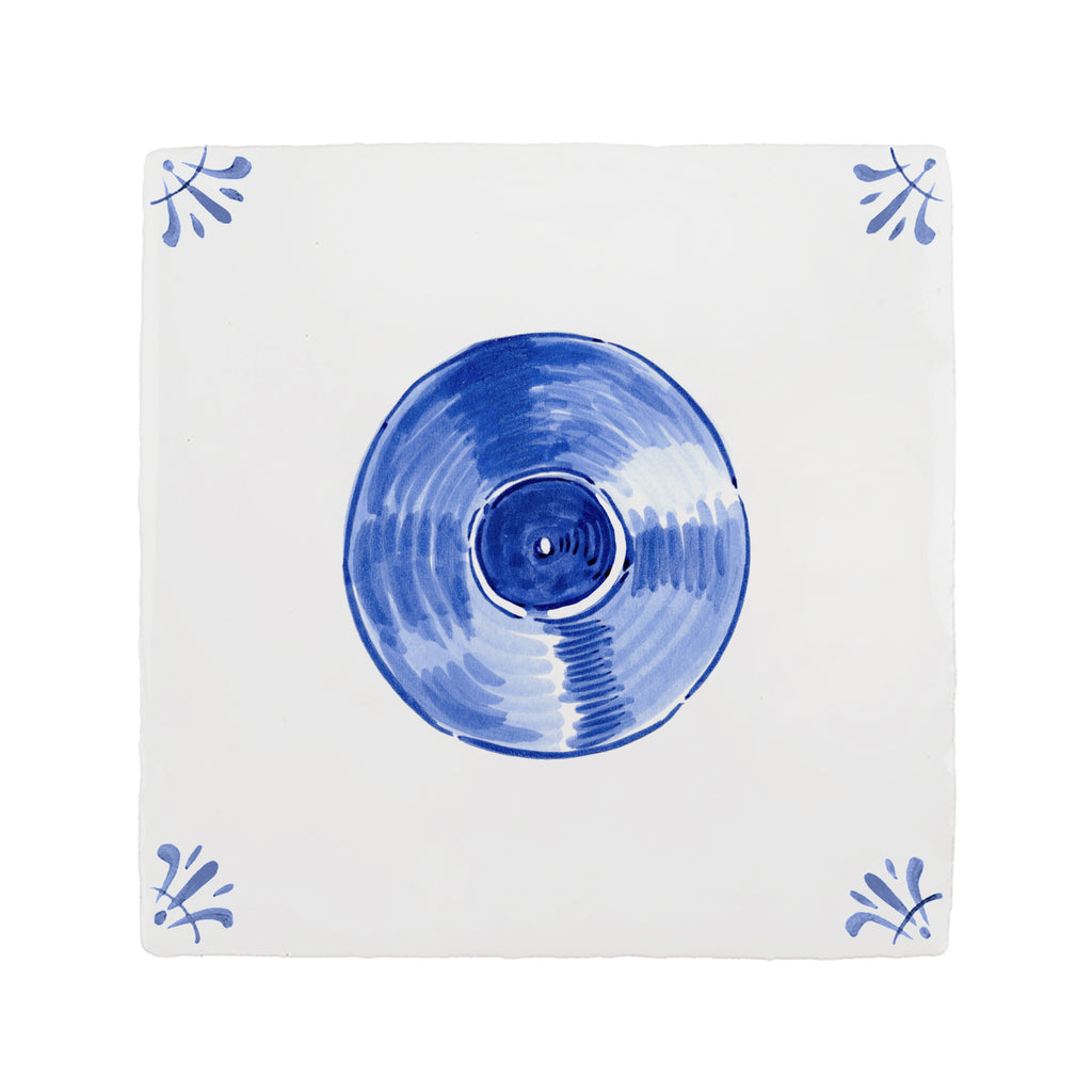 Blue vinyl record on a white tile with decorative blue patterns